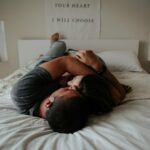 A man and woman cuddling together in bed