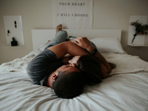 A man and woman cuddling together in bed